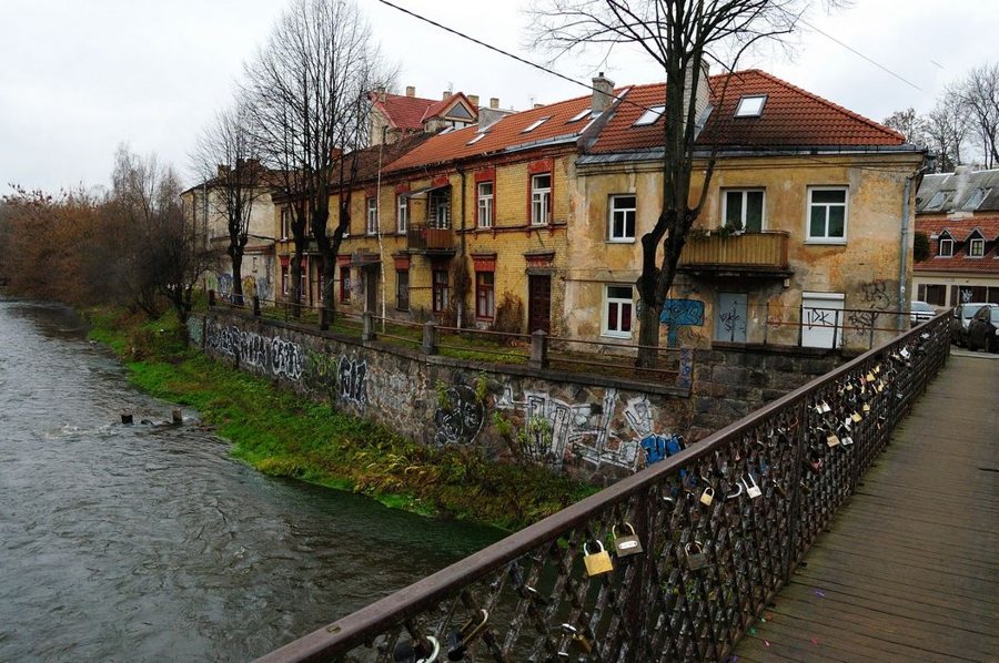 Bridge over the Vilnelė with riverside buildings in Užupis